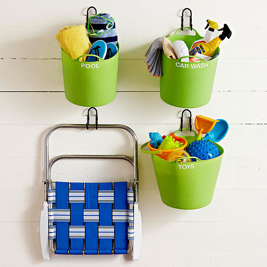 Hang some labeled plastic tubs on the wall to store kids toys and other backyard items! Found on BHG.